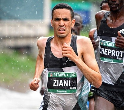 Moroccoâ€™s Mohammed Ziani and Tigist Girma of Ethiopia beat the rain and cold weather to take top honours at the Guangzhou Marathon