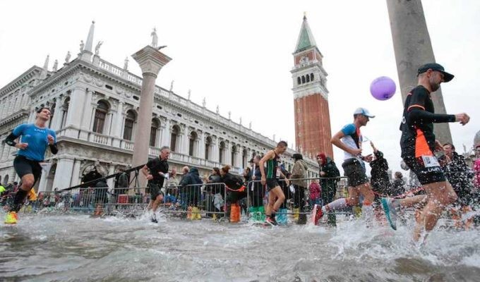 Runners were forced to wade through ankle-deep water at the Venice marathon, Yuki Kawauchi finished seventh, in 2:27:40